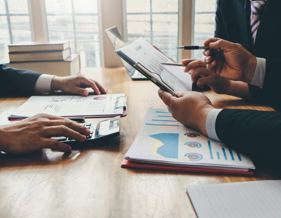 Group of business people meeting together to assess business profits.